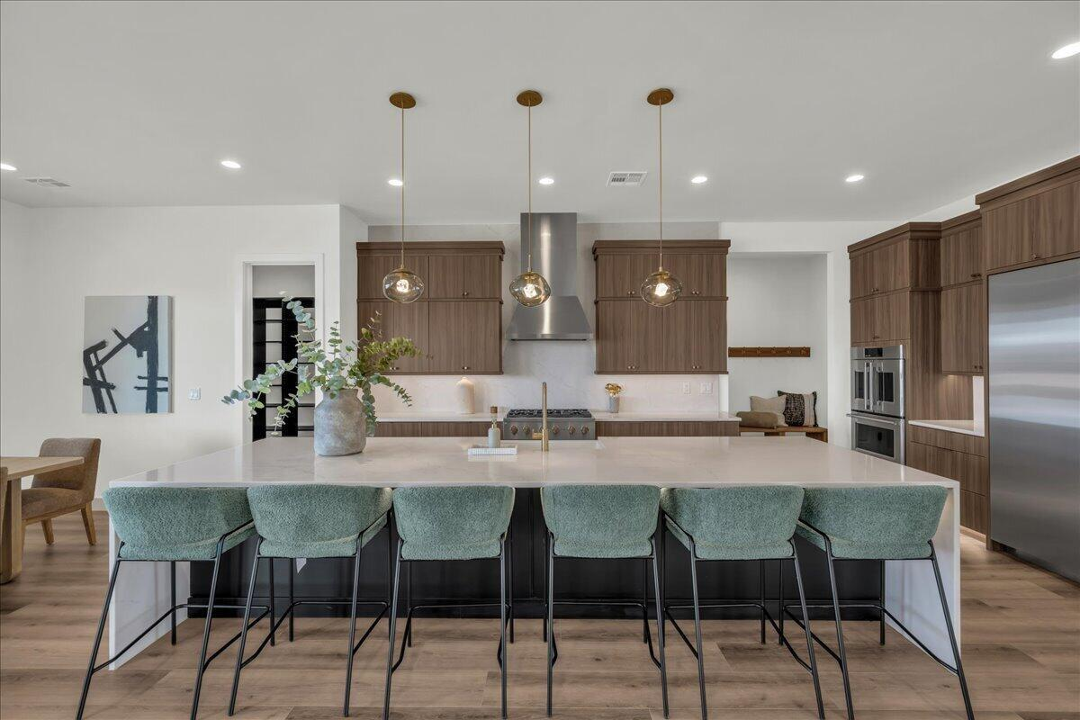 modern kitchen with big island and green stools
